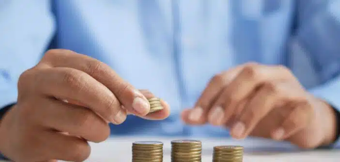 a person stacking coins on top of a table