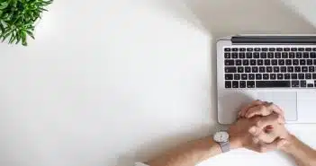 person wearing watch near laptop