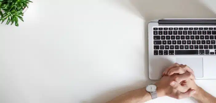 person wearing watch near laptop