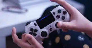 person holding white and black game controller