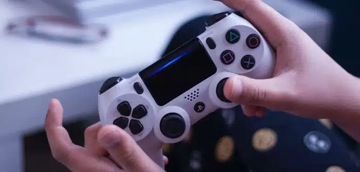 person holding white and black game controller